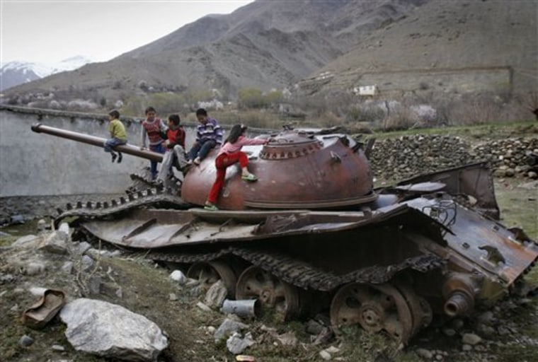Afghan children play on a destroyed Soviet-made armored tank in Panjshir north of Kabul, Afghanistan, on March 26. 